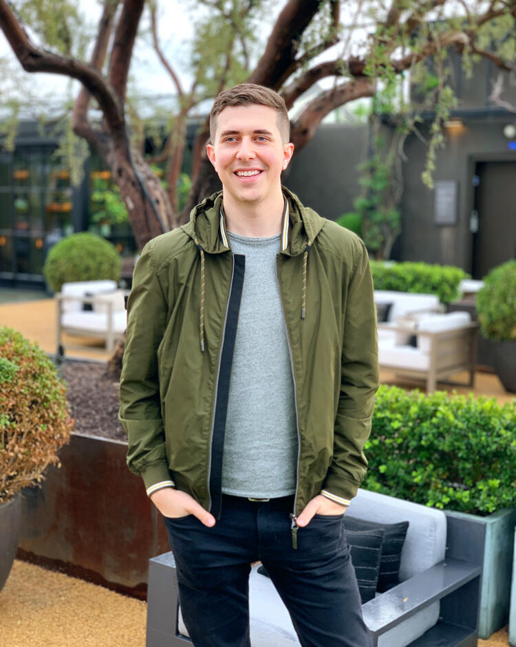 Brandon Hyman standing on a verdant rooftop after a rainstorm